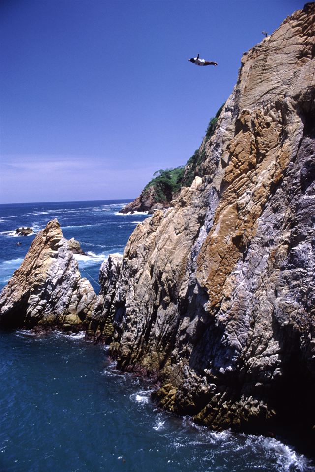 La Quebrada cliff and diver high above the surf in Acapulco