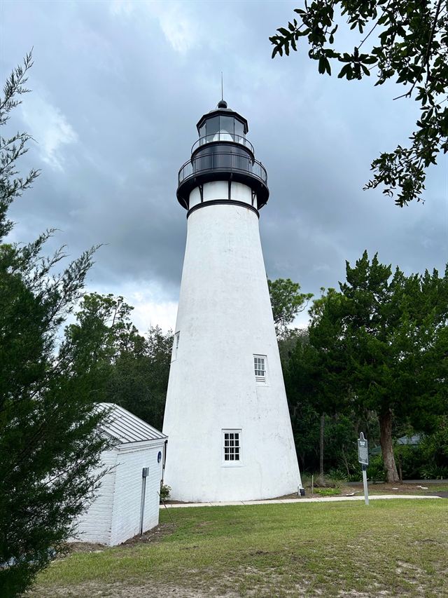 White Amelia Island Lighthouse in Fernandina Beach surrounded by trees