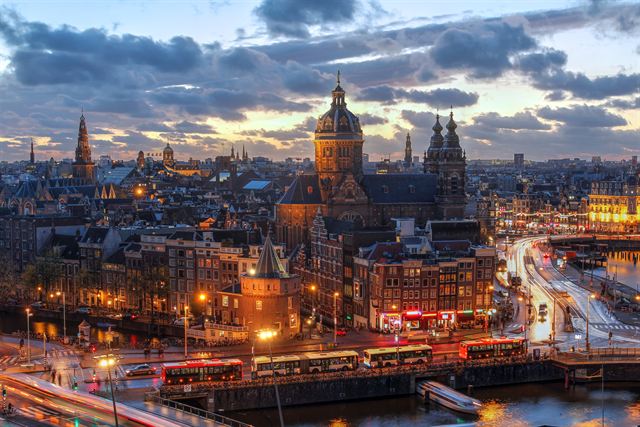 Amsterdam old-town skyline with the Basilica of St. Nicholas at dusk