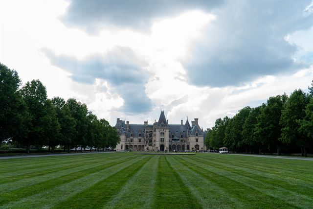 The chateau-style Biltmore House at the end of its long striped lawn and tree-lined esplanade in Asheville