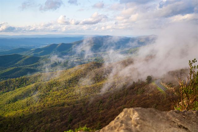 Aerial view of green Blue Ridge Mountain ridges with drifting mist near Asheville, North Carolina