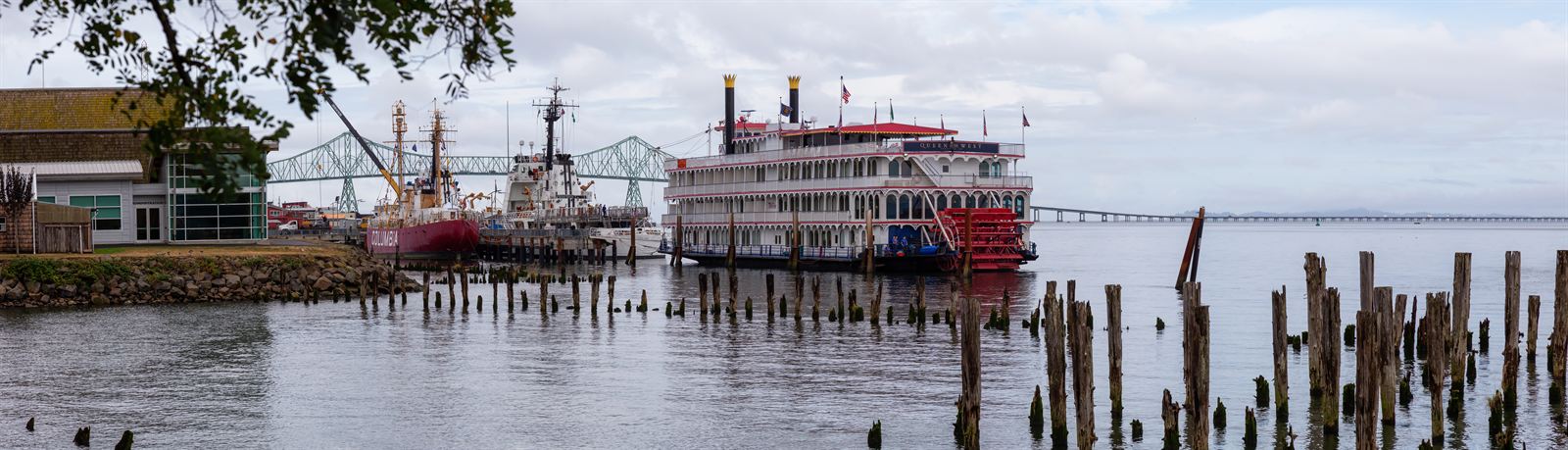 Astoria waterfront with piers, a sternwheeler and the Astoria-Megler Bridge