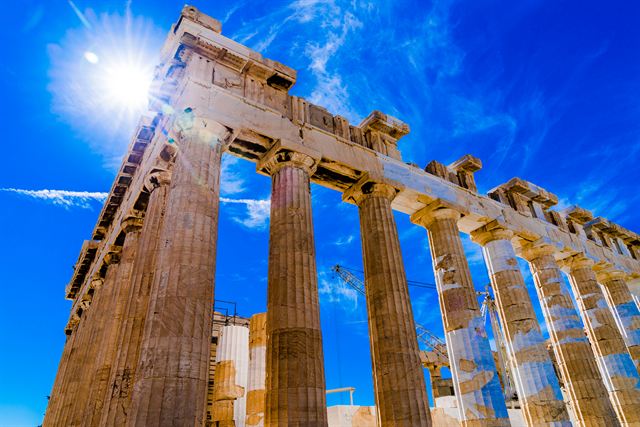 Columns of the Parthenon against a bright blue sky