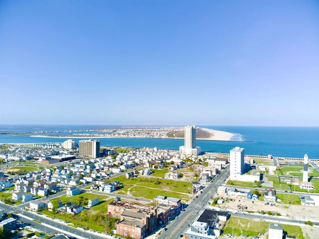 Aerial view of Atlantic City in summer with casino towers, rooftops and the Atlantic coastline
