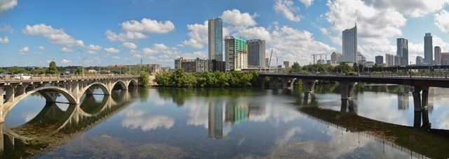 Lamar Bridge crossing Lady Bird Lake with downtown Austin towers reflected in the water, Texas