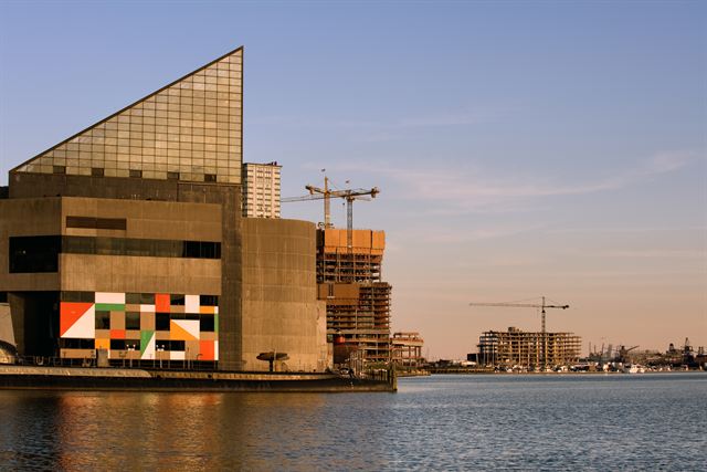 National Aquarium's glass-pyramid building on the Inner Harbor waterfront in Baltimore at golden hour