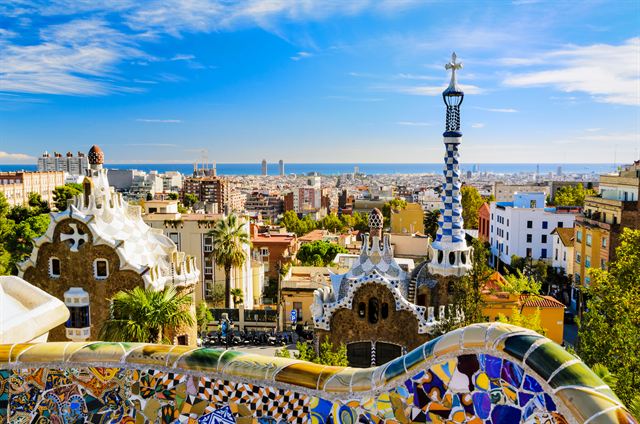 Park Guell's mosaic terrace and Gaudi pavilions overlooking Barcelona and the sea
