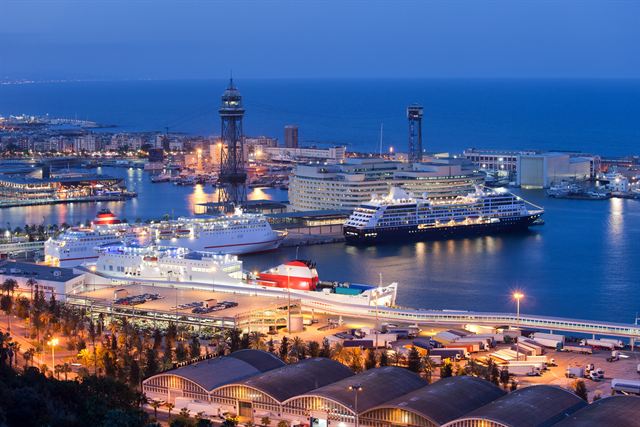 Barcelona port at dusk with cruise ships and ferries below the harbour cable-car towers