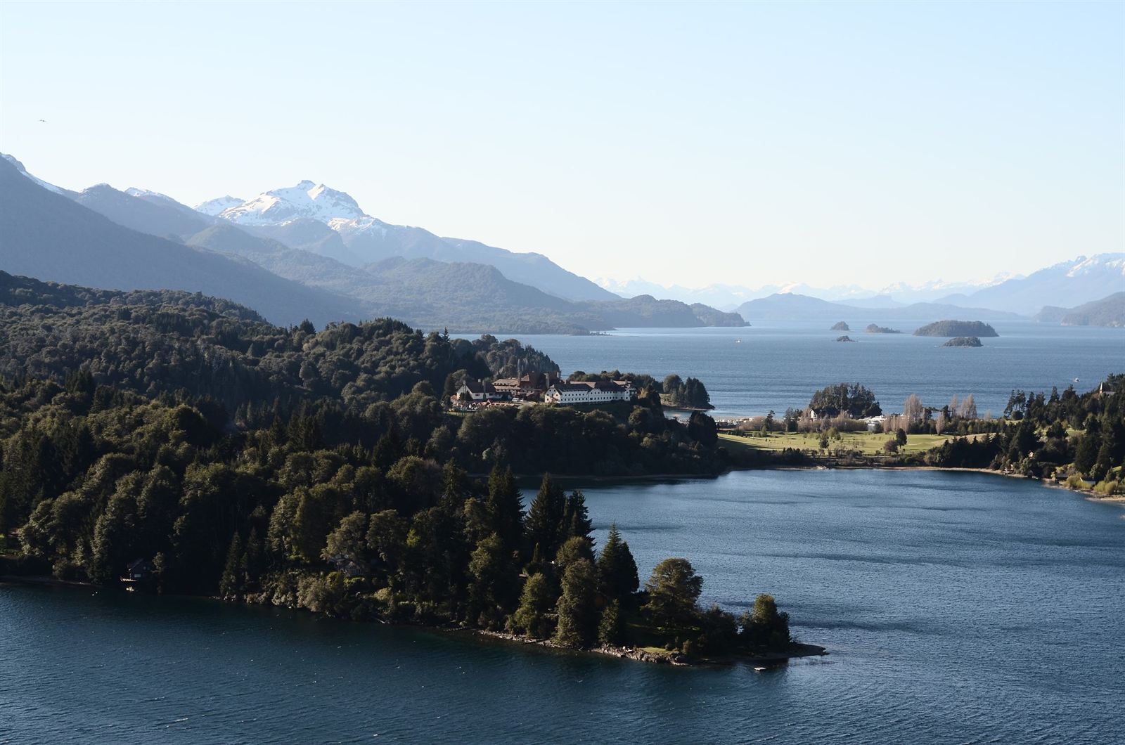Forested peninsula on Lake Nahuel Huapi near Bariloche with snow-dusted Andes peaks beyond