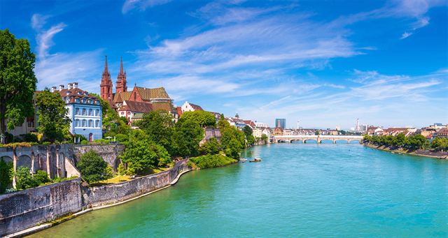 Rhine River in Basel with the twin-spired Minster on the bank and the Middle Bridge