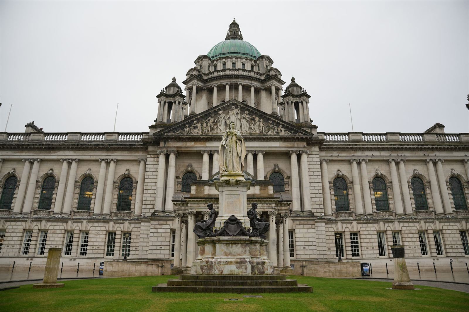 Belfast City Hall's domed Baroque Revival facade with Queen Victoria statue and front lawn