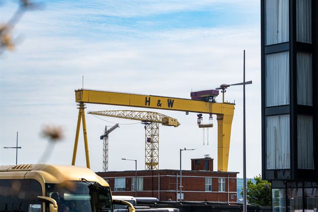 Yellow Harland & Wolff shipyard gantry crane (H&W) rising over Belfast's Titanic Quarter