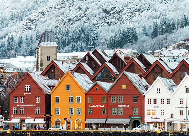 Snow-dusted wooden Bryggen buildings on the Bergen waterfront in winter