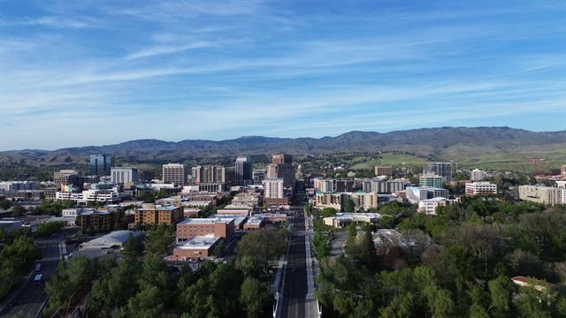 Aerial view of downtown Boise, Idaho with Capitol Boulevard leading to the city and the foothills