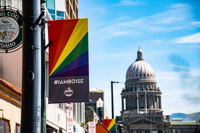 Idaho State Capitol dome at the end of a downtown Boise street with an #IAMBOISE banner