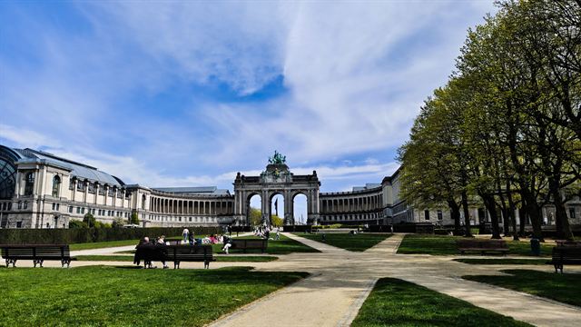 Cinquantenaire Park in Brussels with its triumphal arch and curved colonnades beyond green lawns