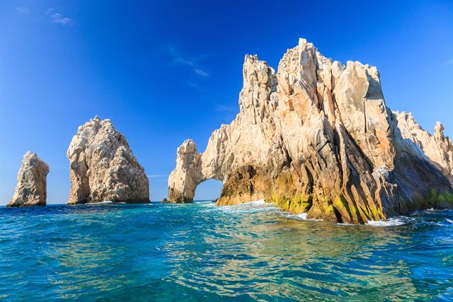 El Arco rock arch at Land's End rising from deep-blue water in Cabo San Lucas