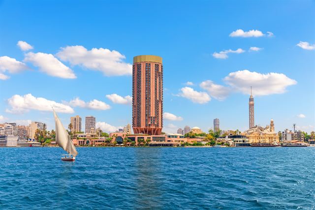Felucca sailing on the Nile past the Cairo skyline and Cairo Tower