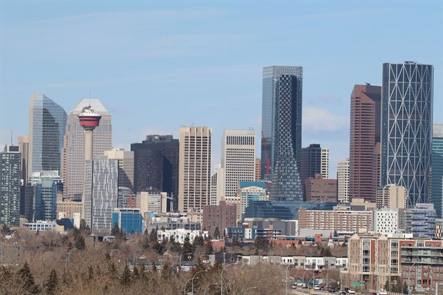 Downtown Calgary skyline with the Calgary Tower, the Bow and Telus Sky towers under a blue sky