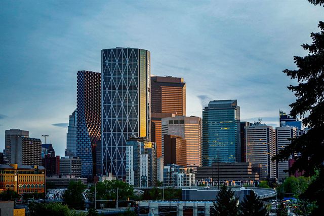 Diagonal-grid Bow tower and neighboring downtown Calgary high-rises in warm late-day light