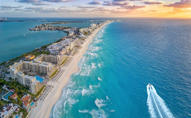 Aerial view of Cancun's Hotel Zone strip of beachfront hotels between turquoise sea and lagoon