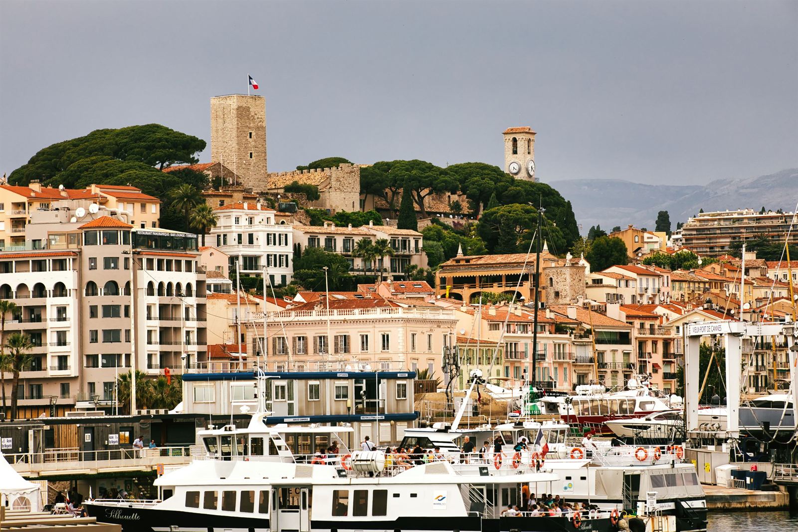 Le Suquet old town of Cannes with its castle tower and church above the Old Port yachts