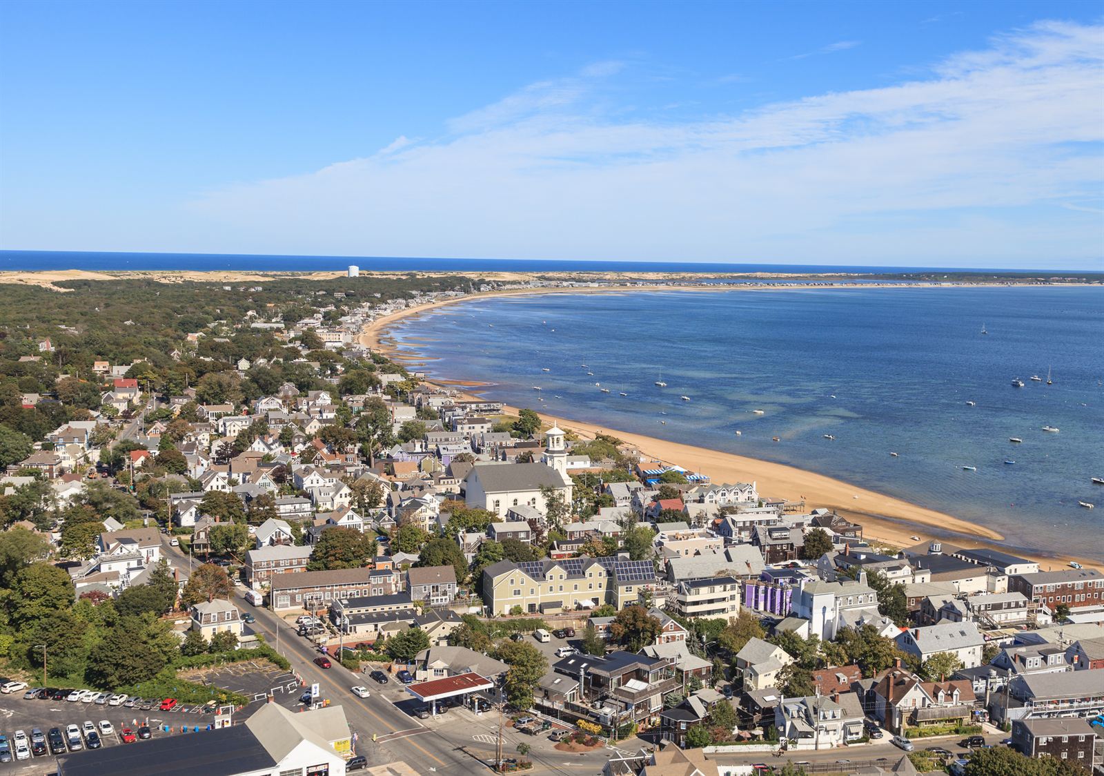 Aerial view of Provincetown's harbor, town and curving bay beach on Cape Cod
