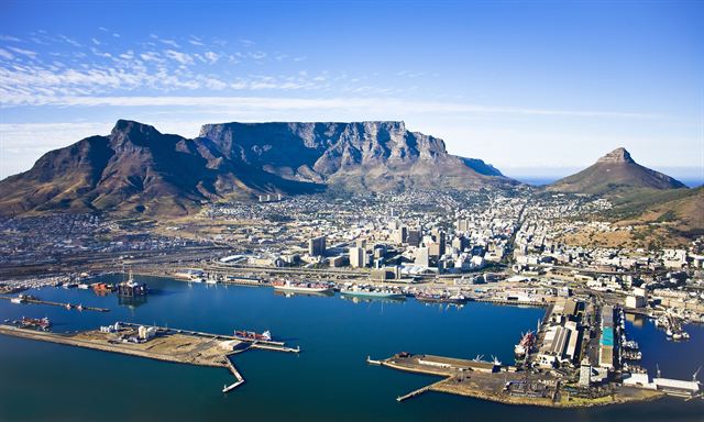 Table Mountain and Lion's Head across Table Bay with surf in the foreground