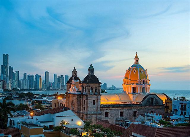 San Pedro Claver church domes in Cartagena's walled old town with Bocagrande's high-rises beyond