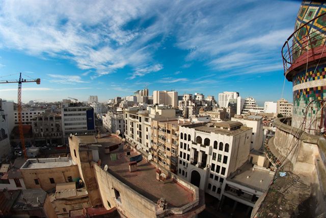 High-angle view over white apartment blocks of central Casablanca under a blue sky