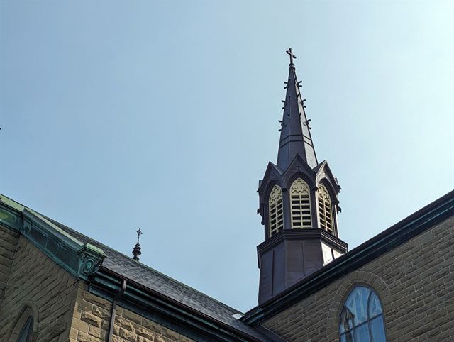 Gothic spire and belfry of a historic stone church in Charlottetown, Prince Edward Island