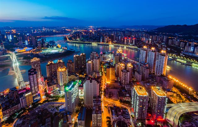 Chongqing skyline lit up at night where the Yangtze and Jialing rivers meet