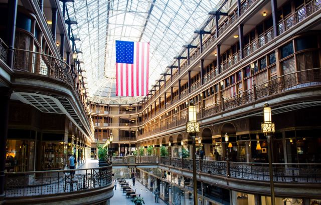 Interior of The Arcade Cleveland, a Victorian glass-roofed shopping arcade hung with a large American flag