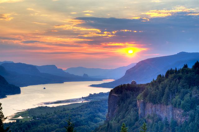Sunset over the Columbia River Gorge from Crown Point with Vista House on the cliff