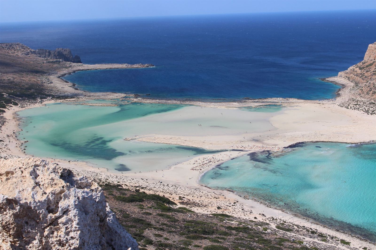 Balos Lagoon in western Crete, white sand spit and turquoise shallows below rocky headland