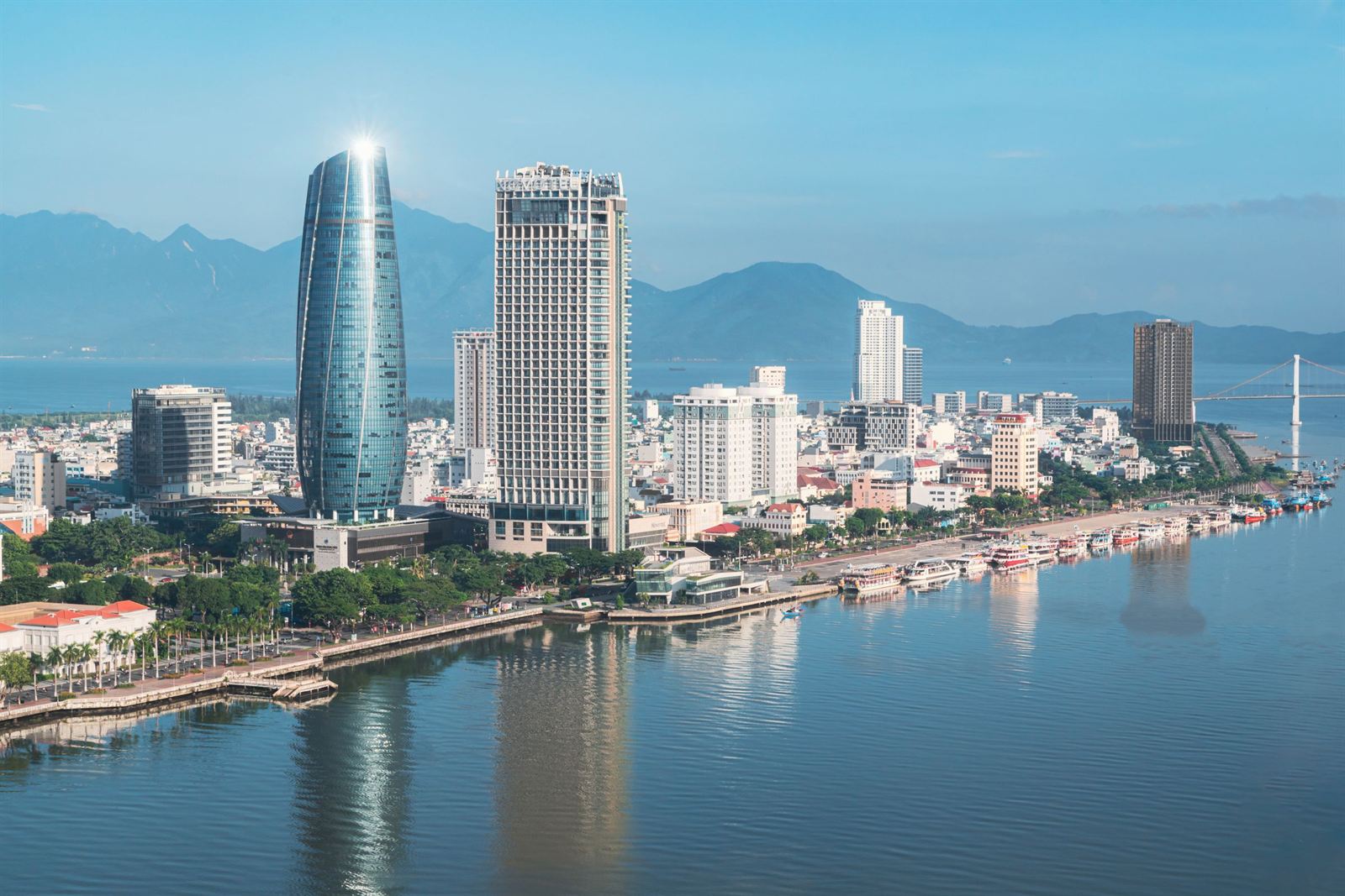 Da Nang skyline along the Han River with the Administrative Center tower and mountains behind
