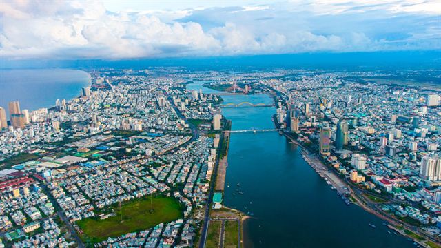 Aerial view of Da Nang city, the Han River bridges and the coastline stretching to the sea