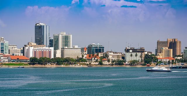 Dar es Salaam city-center skyline along the harbor waterfront with ferries