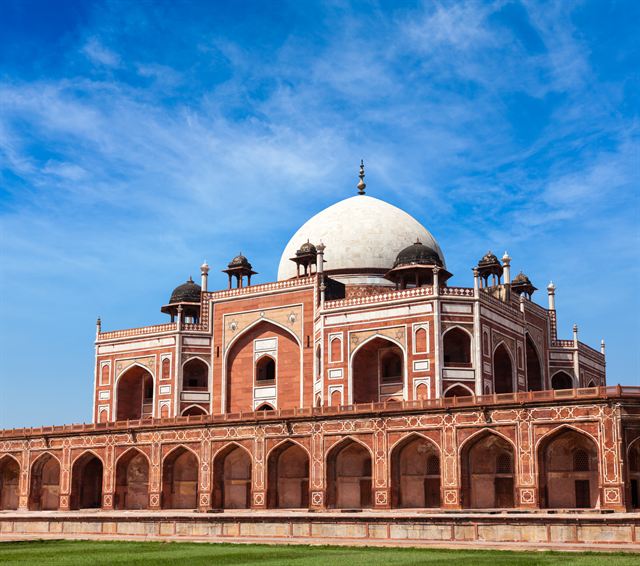 Humayun's Tomb in Delhi, red sandstone and white marble dome under blue sky