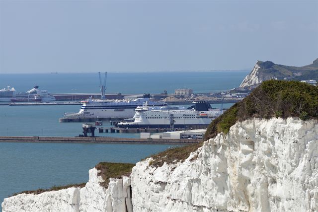 White cliffs of Dover above the port with ferries docked at the terminal, England