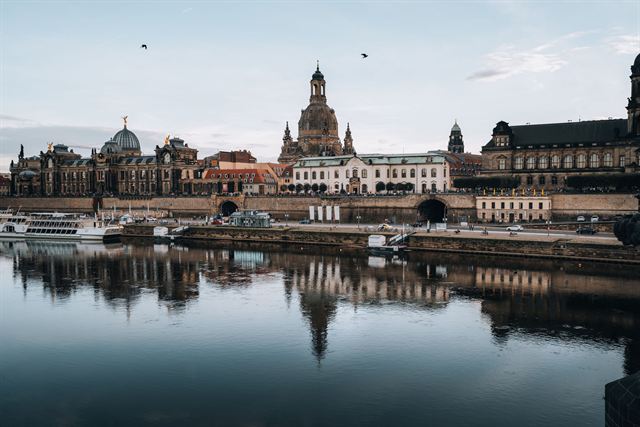Dresden's Elbe riverfront skyline with the Frauenkirche dome reflected in still water