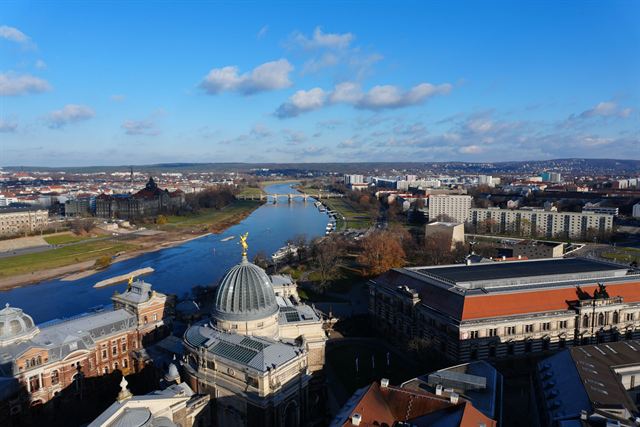 Aerial view over Dresden with the Academy of Fine Arts glass dome and the Elbe river winding away