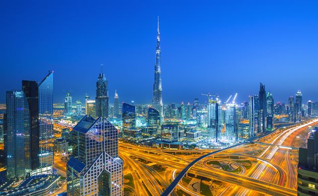 Dubai skyline at dusk with Burj Khalifa and light trails on Sheikh Zayed Road interchanges