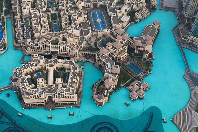 Top-down view from Burj Khalifa over the Dubai Fountain lake and Souk Al Bahar rooftops
