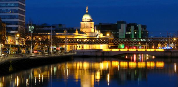 Dublin Custom House dome illuminated at night beside the River Liffey quays