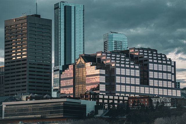Downtown Edmonton office towers including Canada Place under a moody cloudy sky