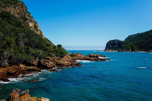 Knysna Heads sandstone cliffs framing the lagoon entrance and deep blue sea, South Africa
