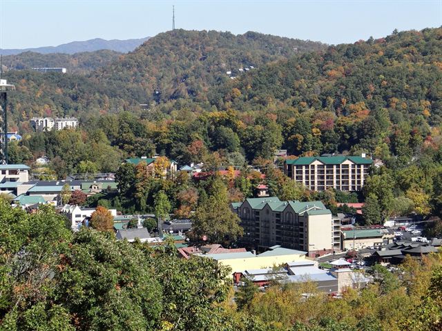 Gatlinburg, Tennessee hotels and houses nestled in a forested valley of the Smoky Mountains