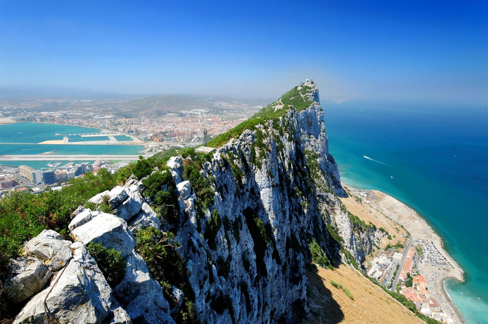 Aerial view along the limestone ridge of the Rock of Gibraltar above the town and sea