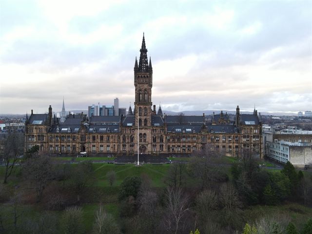 Aerial view of the University of Glasgow's Gothic Revival main building and tower above Kelvingrove Park